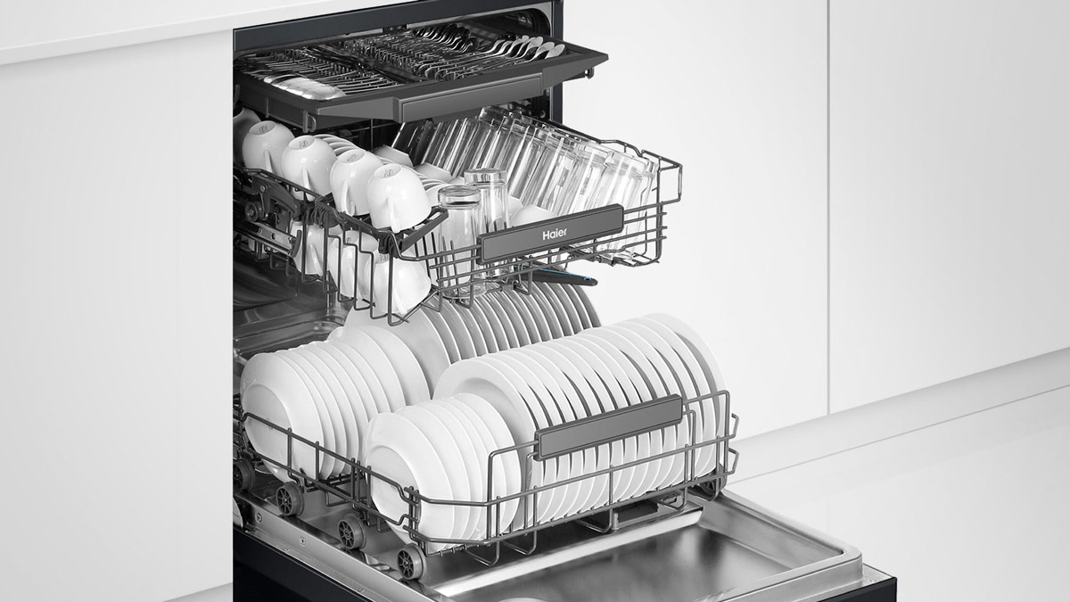 an open dishwasher with a full load of dishes